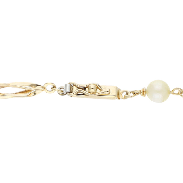 Pulsera eslabón articulado con aplicaciones de perlas en oro amarillo 14 kilates.