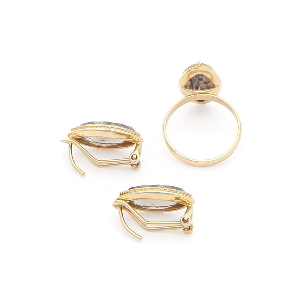 Juego de anillo y aretes torzal con topacio en oro amarillo 14 kilates.