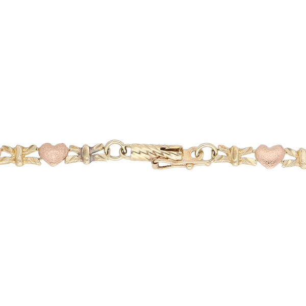 Pulsera eslabón combinado motivo corazón en oro dos tonos 14 kilates.