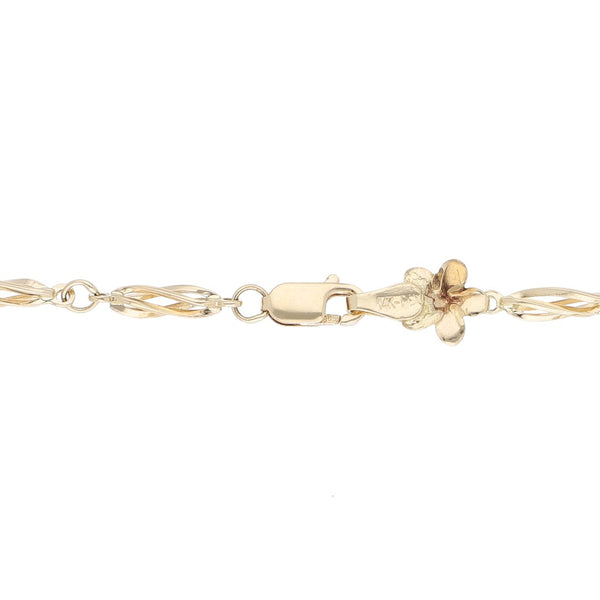 Pulsera eslabón combinado motivo flores en oro amarillo 14 kilates.