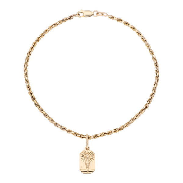 Pulsera eslabón torzal y medalla labrada motivo Cristo en oro amarillo 14 kilates.