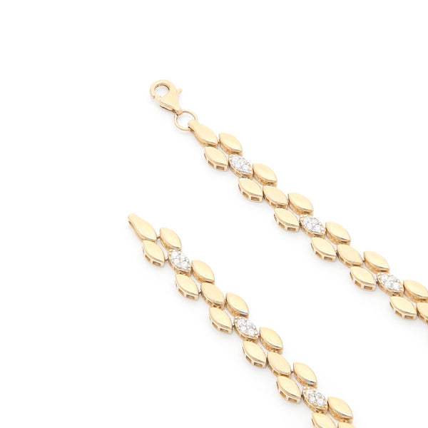 Pulsera eslabón articulado con aplicaciones de circonias en oro amarillo 14 kilates.