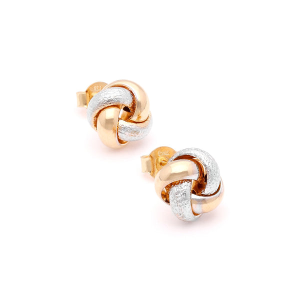 Aretes labrados motivo nudo en oro dos tonos 14 kilates.