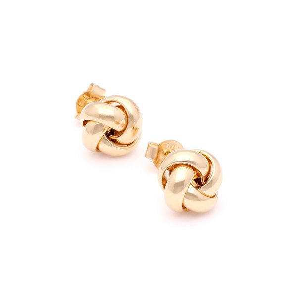 Aretes lisos motivo nudo en oro amarillo 14 kilates.