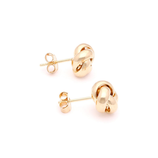 Aretes lisos motivo nudo en oro amarillo 14 kilates.