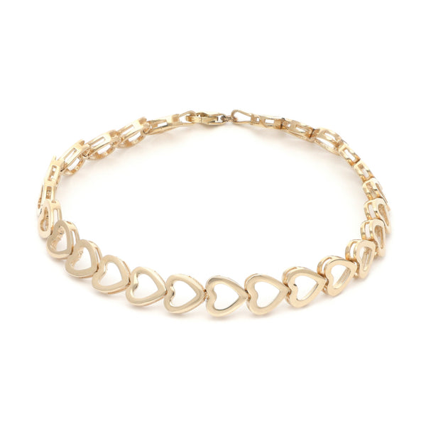 Pulsera eslabón laminado motivo corazón en oro amarillo 14 kilates.