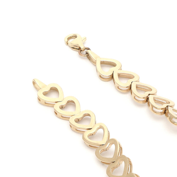 Pulsera eslabón laminado motivo corazón en oro amarillo 14 kilates.