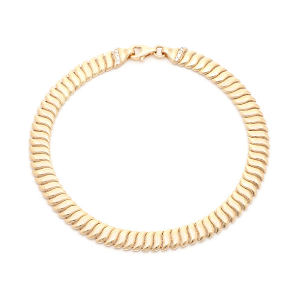 Pulsera eslabón articulado con circonias en oro amarillo 14 kilates.