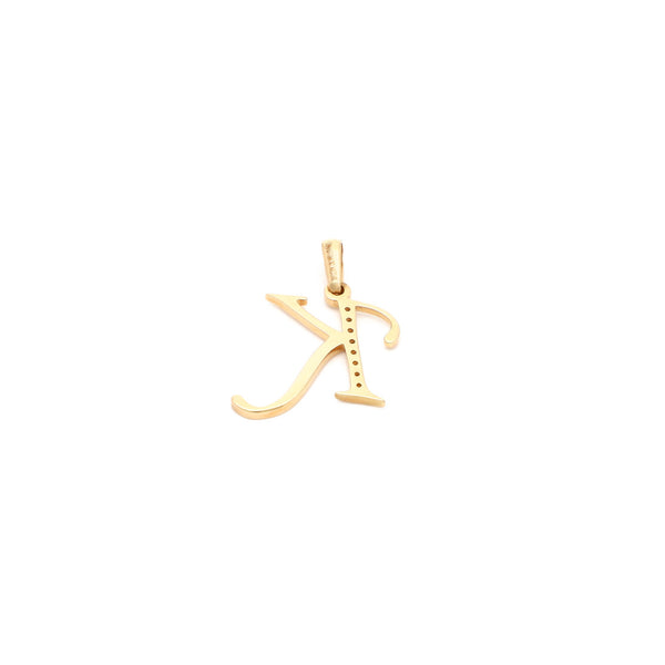 Dije diseño especial motivo letra K con circonias en oro amarillo 14 kilates.
