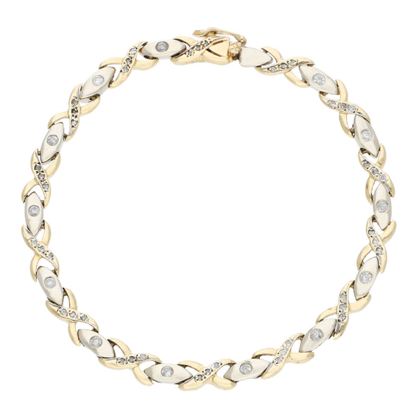 Pulsera eslabón articulado con aplicaciones de diamantes en oro dos tonos 14 kilates.