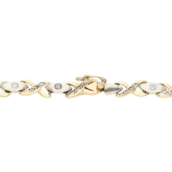 Pulsera eslabón articulado con aplicaciones de diamantes en oro dos tonos 14 kilates.