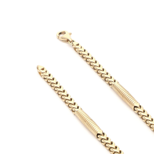 Pulsera eslabón tejido con aplicaciones en oro amarillo 14 kilates.