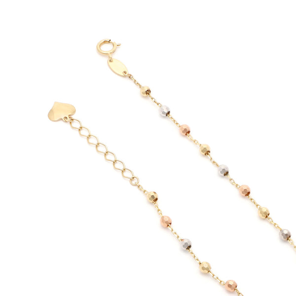 Pulsera eslabón combinado con colgante motivo corazón en oro tres tonos 14 kilates.