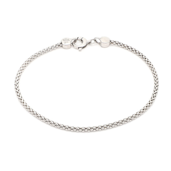 Pulsera eslabón tejido en oro blanco 14 kilates.