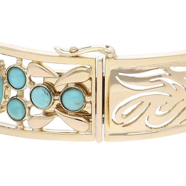 Pulsera de arillo calada con diamantes, zafiros y turquesas en oro amarillo 14 kilates.