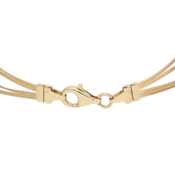 Pulsera eslabón tejido con aplicaciones en oro dos tonos 14 kilates.