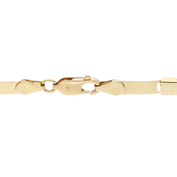Pulsera eslabón laminado con aplicaciones en oro amarillo 14 kilates.