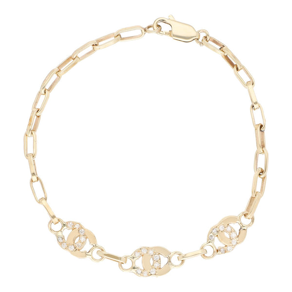 Pulsera eslabón cruzado con aplicaciones y sintéticos en oro amarillo 12 kilates.