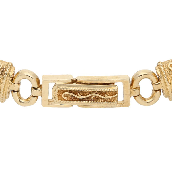 Pulsera eslabón combinado con tres monedas de dos y medio pesos oro amarillo de 21.6 kilates y 14 kilates.