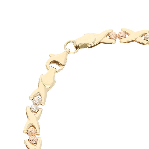 Pulsera eslabón laminado con aplicaciones en oro tres tonos 14 kilates.