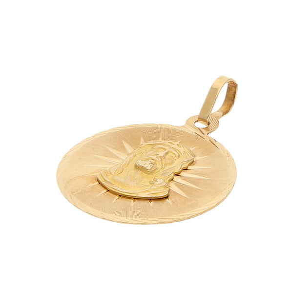 Medalla labrada motivo Divino Rostro en oro amarillo 14 kilates.