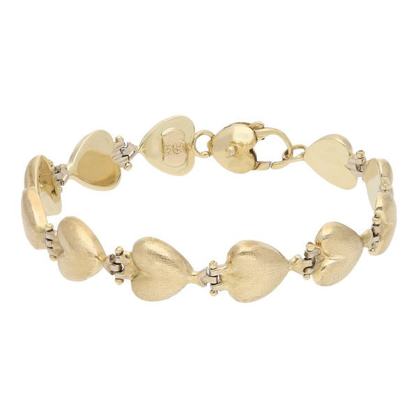 Pulsera eslabón articulado motivo corazón en oro amarillo 14 kilates.