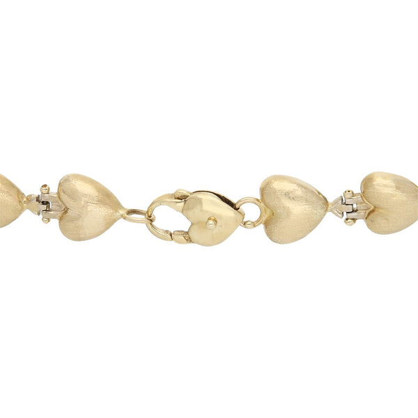 Pulsera eslabón articulado motivo corazón en oro amarillo 14 kilates.