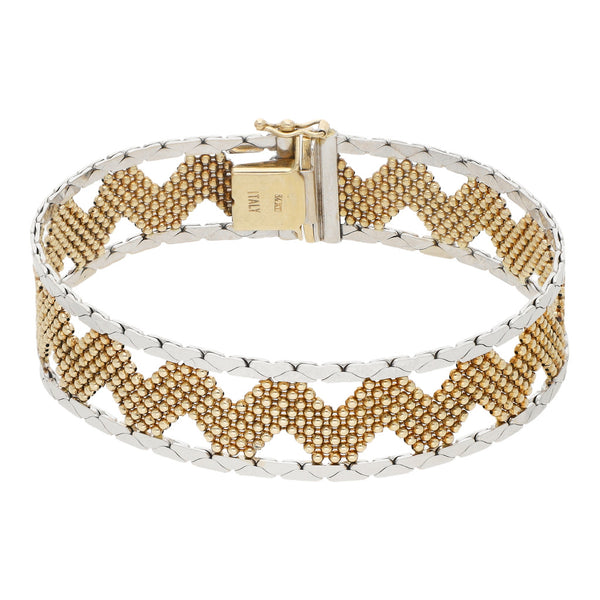 Pulsera eslabón laminado con aplicaciones en oro dos tonos 14 kilates.
