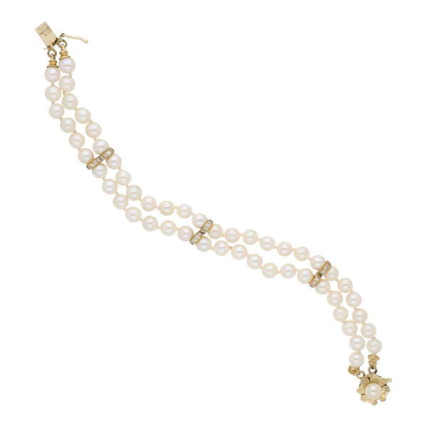 Pulsera eslabón articulado de perlas con aplicaciones de sintéticos en oro amarillo 14 kilates.