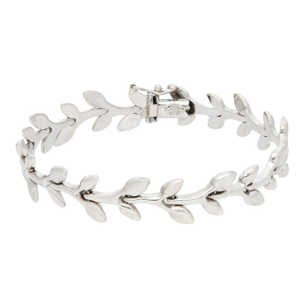Pulsera eslabón articulado motivo hojas en oro blanco 14 kilates.