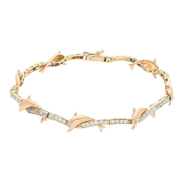 Pulsera eslabón articulado con aplicaciones y sintéticos motivo delfín en oro dos tonos 14 kilates.