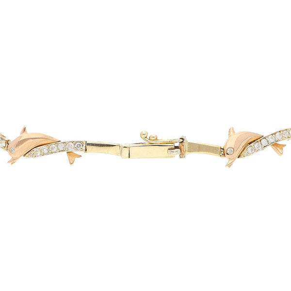 Pulsera eslabón articulado con aplicaciones y sintéticos motivo delfín en oro dos tonos 14 kilates.