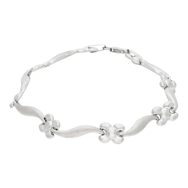 Pulseras eslabón articulado motivo flor en oro blanco 14 kilates.