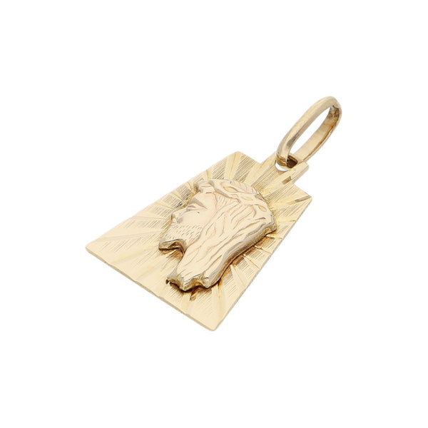 Medalla labrada motivo Divino Rostro en oro amarillo 14 kilates.