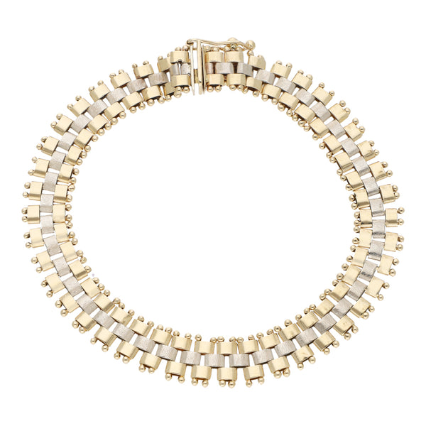 Pulsera eslabón articulado en oro dos tonos 14 kilates.