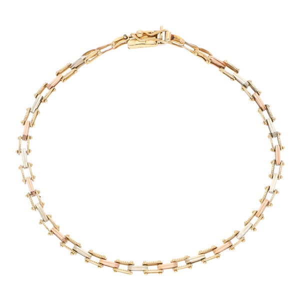 Pulsera eslabón articulado en oro tres tonos 14 kilates.