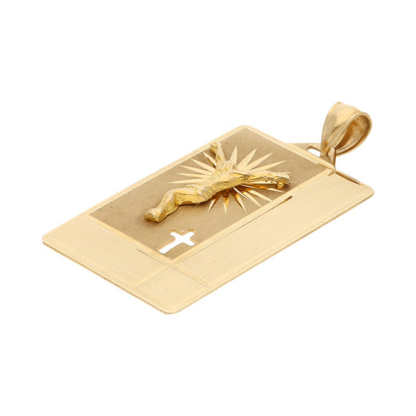 Medalla laminada motivo Cristo en oro amarillo 14 kilates.
