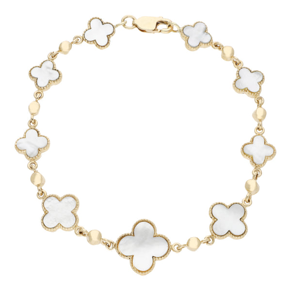 Pulsera eslabón articulado con aplicaciones de madre perla en oro amarillo 14 kilates.