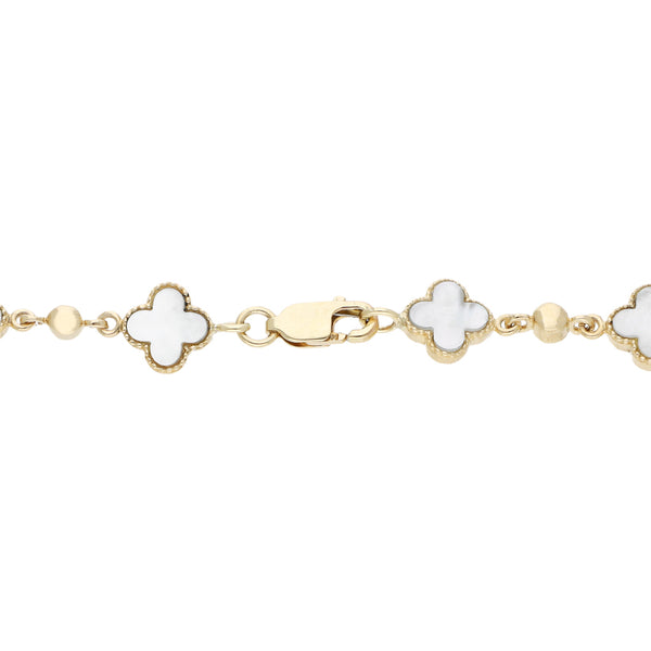 Pulsera eslabón articulado con aplicaciones de madre perla en oro amarillo 14 kilates.