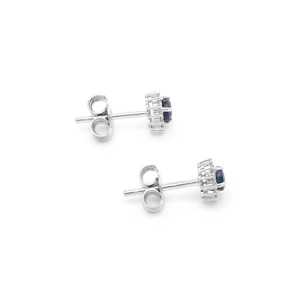 Aretes diseño especial con diamantes y zafiro en oro blanco 14 kilates.