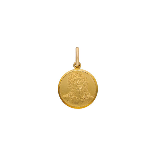 Medalla labrada motivo Divino Rostro en oro amarillo 18 kilates.