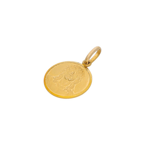 Medalla labrada motivo Divino Rostro en oro amarillo 18 kilates.
