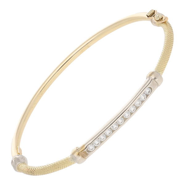 Pulsera de arillo articulada con aplicaciones y circonias en oro dos tonos 14 kilates.
