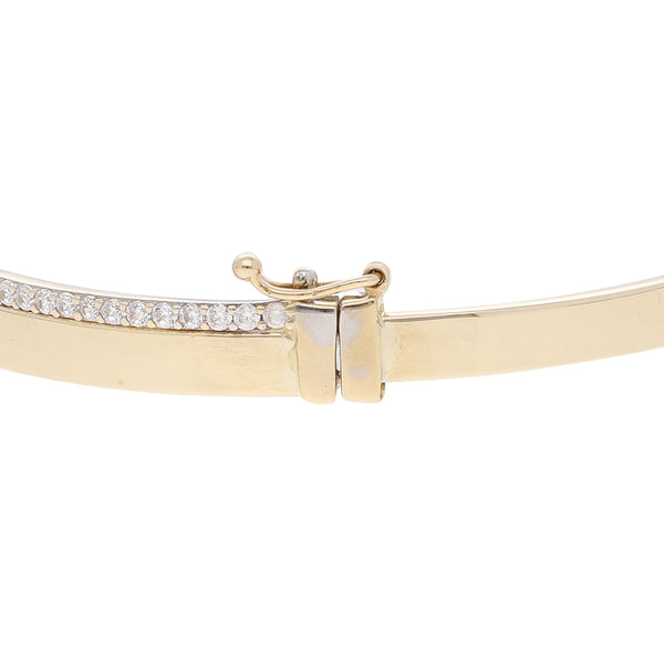 Pulsera de arillo articulada con circonias en oro dos tonos 14 kilates.