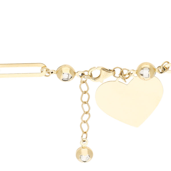 Pulsera eslabón cruzado con aplicaciones, sintéticos y colgante motivo corazón en oro amarillo 14 kilates.