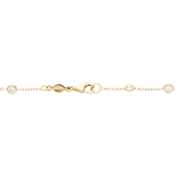 Pulsera eslabón cruzado con aplicaciones motivo círculos con sintéticos en oro amarillo 14 kilates.