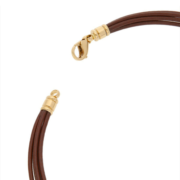 Gargantilla en piel con broche y casquillos en oro amarillo 18 kilates y dije diseño especial motivo corazón firma Bvlgari en acero y oro amarillo 18 kilates.