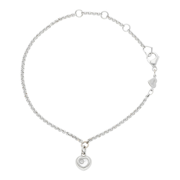 Pulsera eslabón cruzado firma Chopard con colgante motivo corazón con diamante flotante en oro blanco 18 kilates.