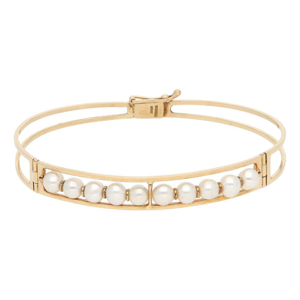 Pulsera de arillo articulada con perlas en oro amarillo 14 kilates.