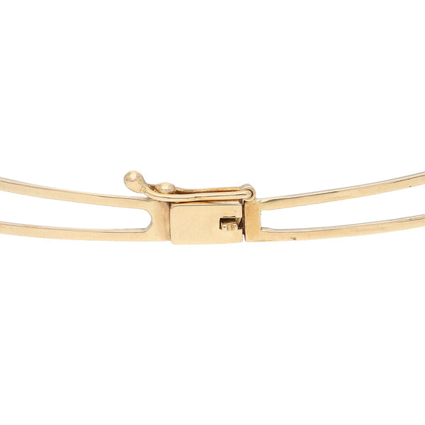 Pulsera de arillo articulada con perlas en oro amarillo 14 kilates.